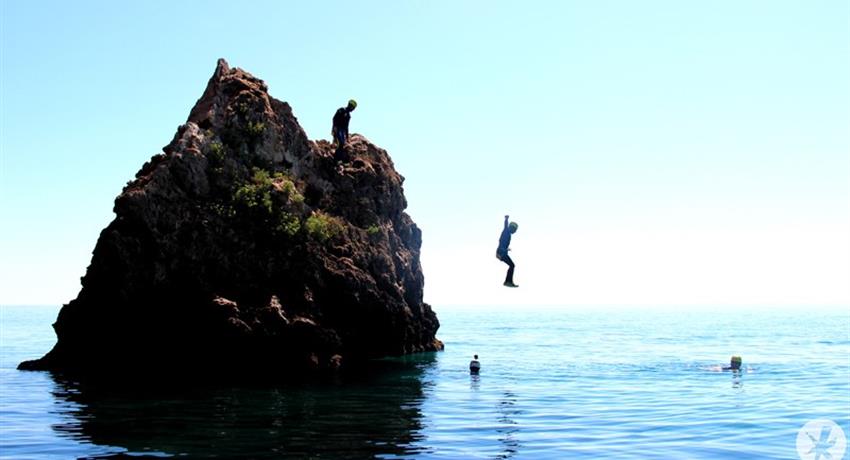 jumping into the water from the cliff - tiqy, Coasteering in Nerja – Malaga