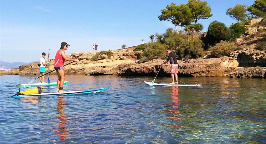 stand up paddle on the way to cala brava - tiqy, Stand Up Paddle Tour in Cala Brava Caves